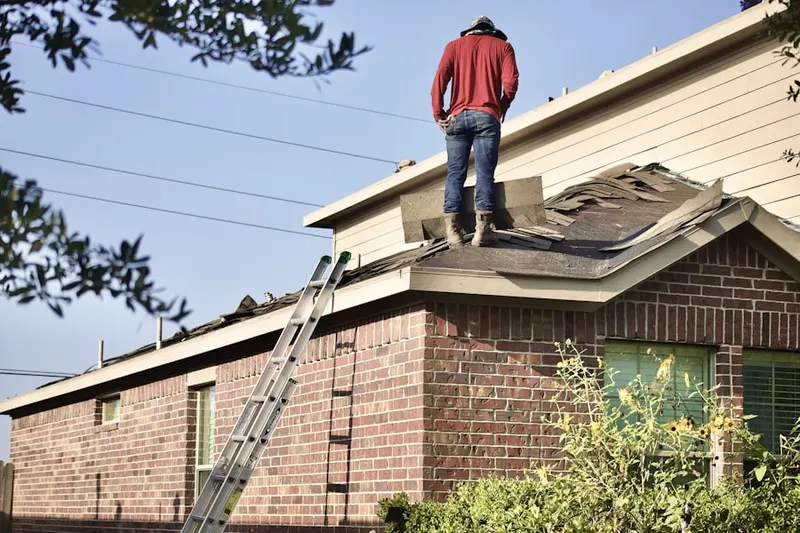 Professional roofer working on a residential roof in Five Locks